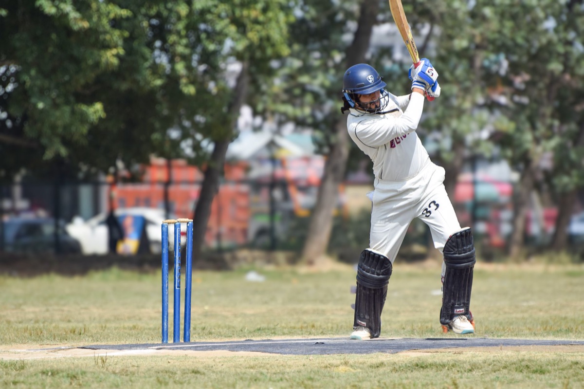 cricket team in white and green uniforms
