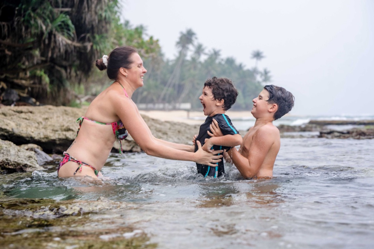 Family swimming in Maldivian beach