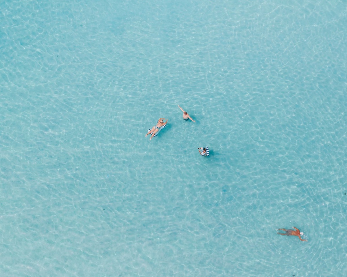 couple swimming in maldivian blue water