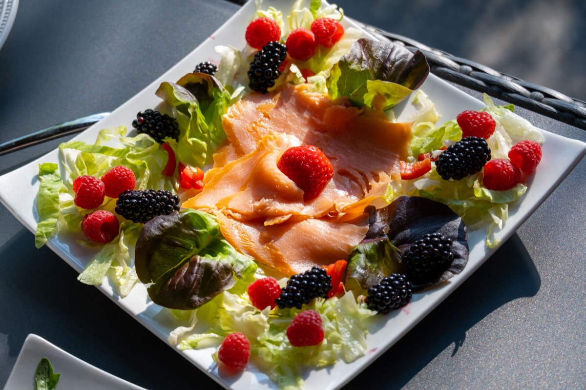tropical fruit and fresh fish on dining table