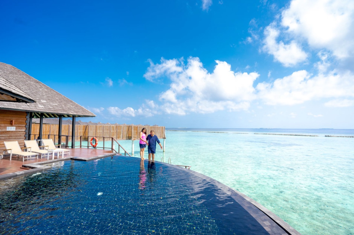 overwater villa with infinity pool and white sand beach