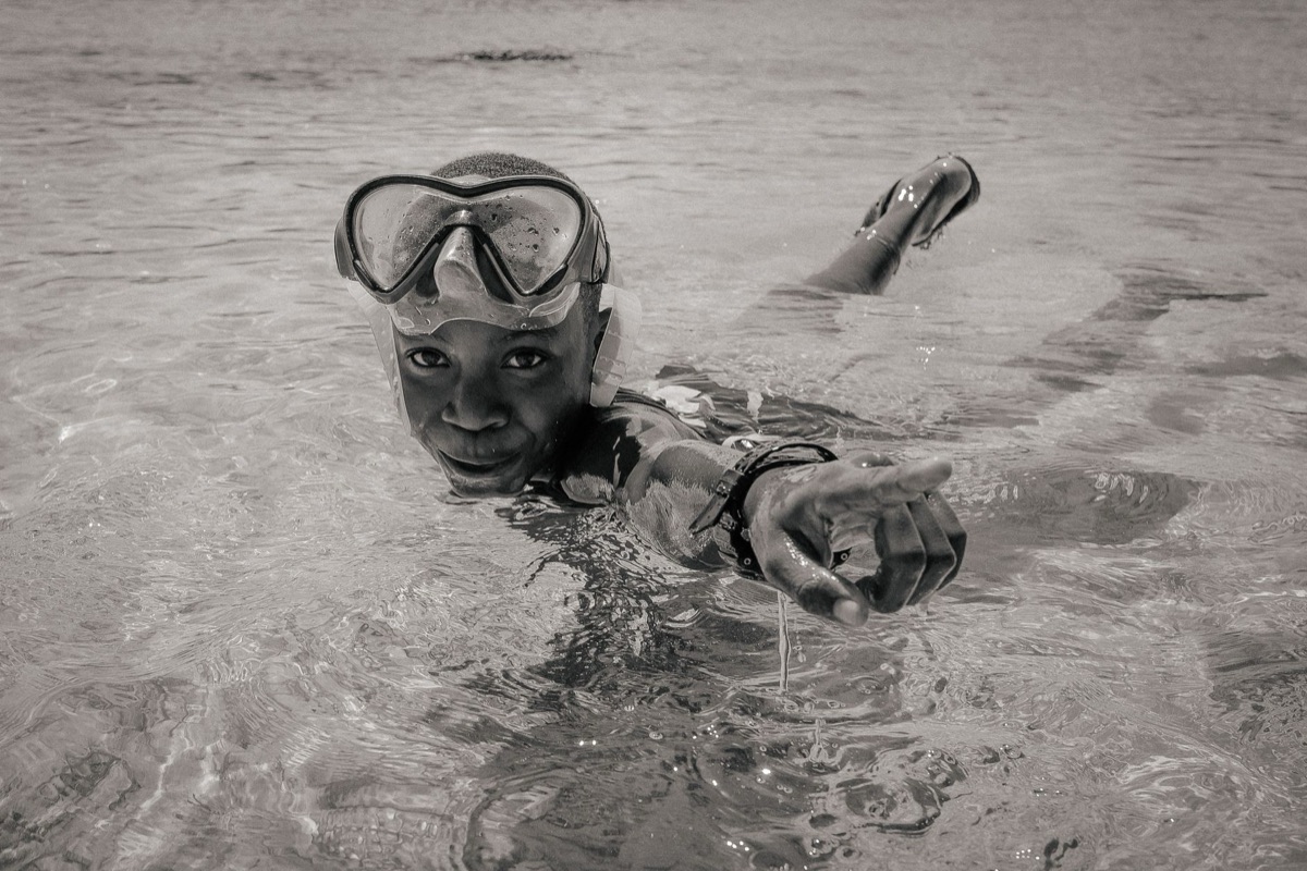 Child wearing snorkel mask in Maldives water