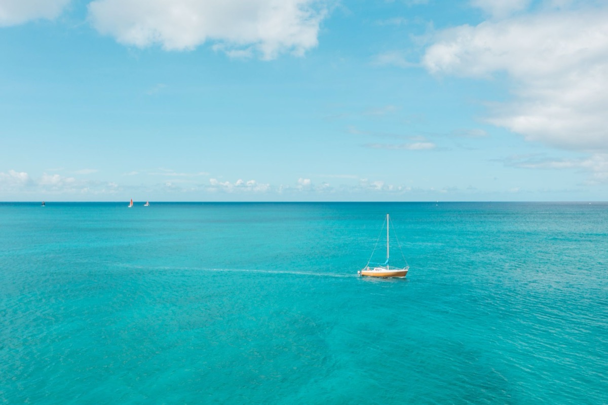 Sailboat in turquoise water near Maldivian resort