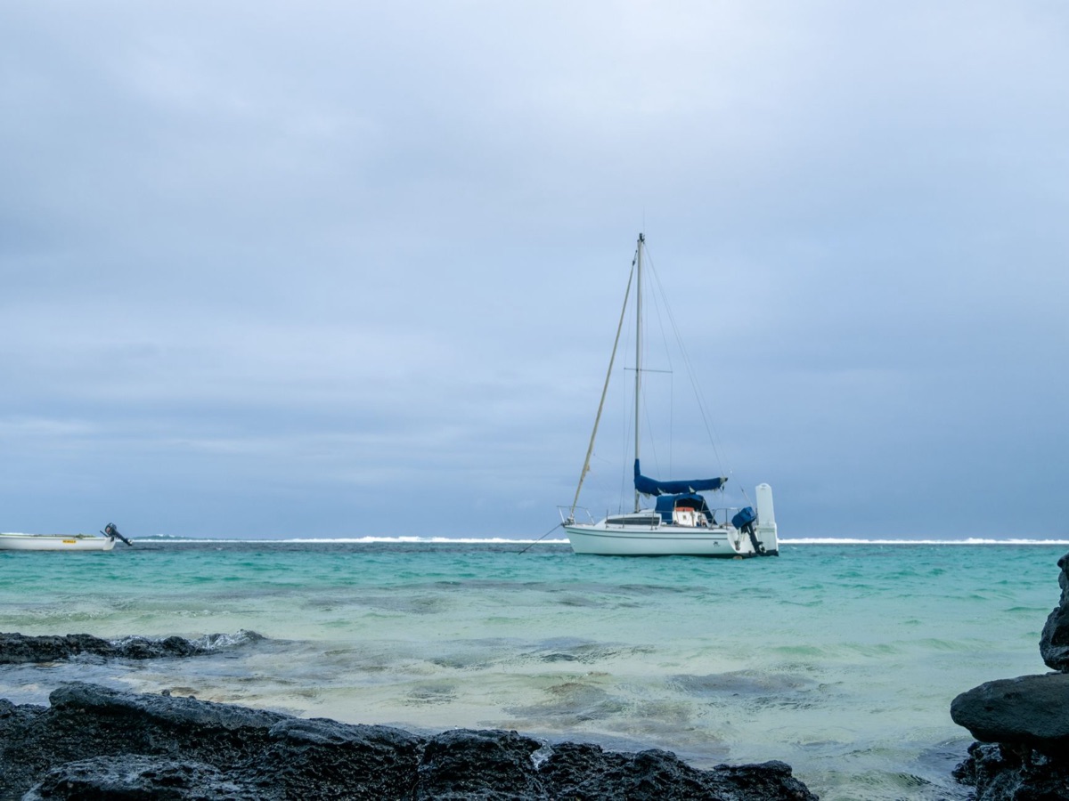 Sailboat in turquoise water near resort